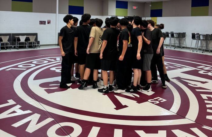  Wrestling team gathers at the center of the mat